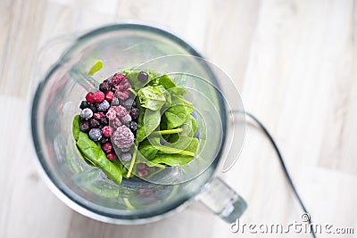 Frozen berries and spinach leaf ready for smoothie blending Stock Photo