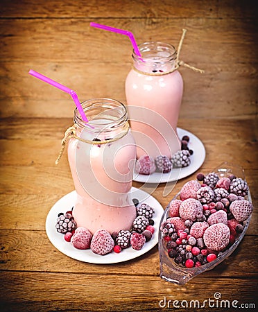 Frozen berry fruits (frozen fruits) and fruit yogurt Stock Photo