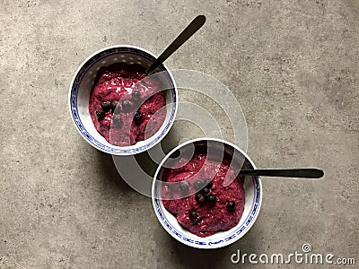 Frozen blueberry chia pudding topped with blueberries in two bowls Stock Photo