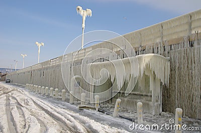 Frozen breakwater and bus stop after winter storm Stock Photo