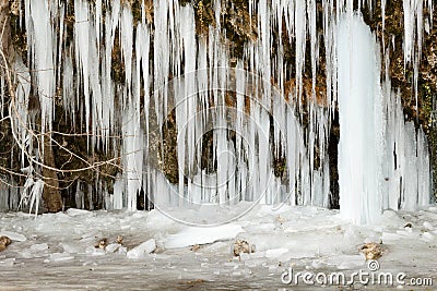 Frozen cave with big sharp icicles Stock Photo