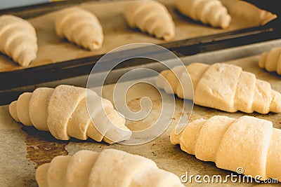 Frozen croissants on cooking paper Stock Photo