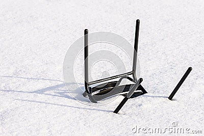 Abandoned chair upside down in the snow. Stock Photo