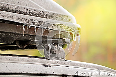 Frozen drops of icy conditions on the trunk and roof of a car, bright sunlight, weather anomalies Stock Photo