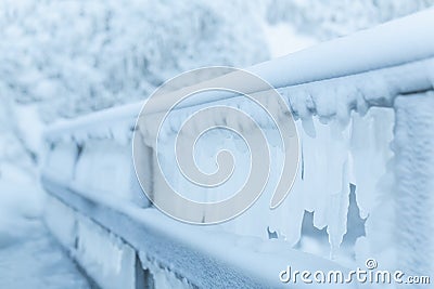 Frozen fence in winter. Huge icicles close up Stock Photo