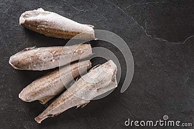 Frozen fillet fishes on slate stone background. Seafood, top view, flat lay, copy space Stock Photo