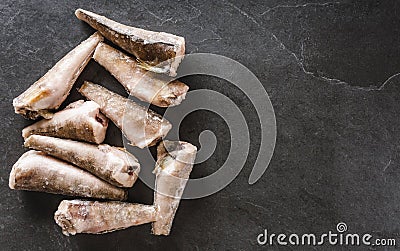 Frozen fillet fishes on slate stone background. Seafood, top view, flat lay, copy space Stock Photo