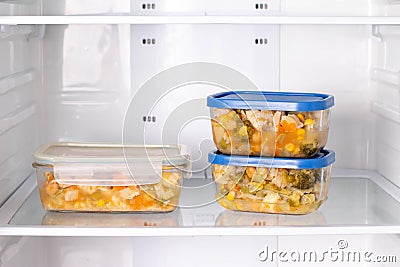 Frozen food in a container in the freezer. Ready meal. Refrigerator with frozen food Stock Photo