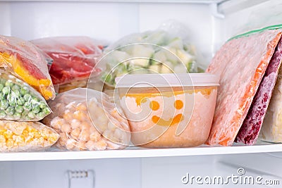 Frozen food in the freezer. Frozen vegetables, soup, ready meals Stock Photo