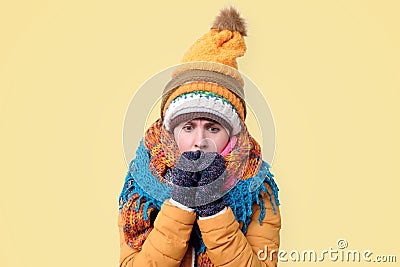 Frozen Girl in hat and scar shivering because of winter weather Stock Photo