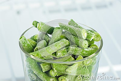 Frozen green beans in a glass in the freezer Stock Photo