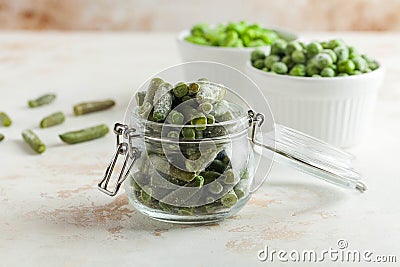 Frozen green beans in a glass jar. Freezing is a safe method of increasing the shelf life of nutritious foods Stock Photo