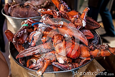Frozen lobster claws in metal bucket at restaurant Stock Photo