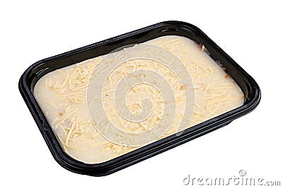 Frozen low cost small square lasagna in black plastic box isolated macro Stock Photo