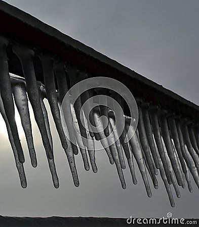 Frozen metal bars with icicles Stock Photo