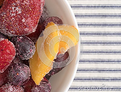 Frozen mixed fruit in a bowl on a tablecloth Stock Photo