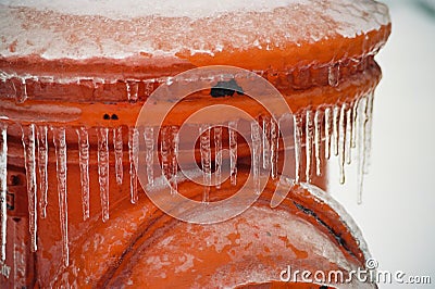 Frozen orange Fire Hydrant after an ice storm Stock Photo