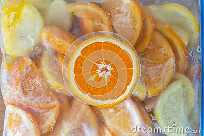 Frozen orange lemon in fridge bag Stock Photo