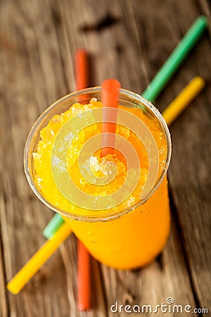 Frozen Orange Slushie in Plastic Cup with Straw Stock Photo