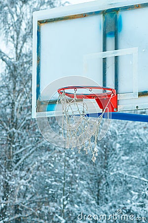 Frozen outdoor basketball hoop in winter snow Stock Photo