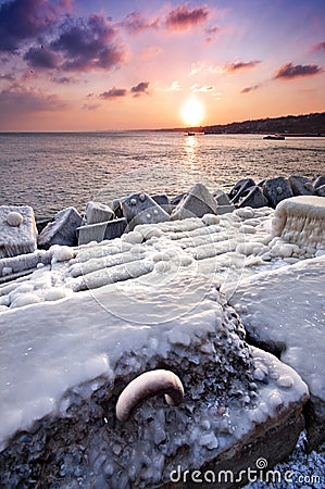 Frozen pier in the sunset Stock Photo