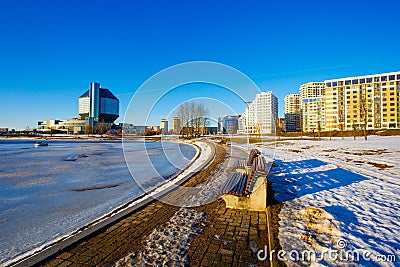 Frozen river flowing near national library in residential area Editorial Stock Photo