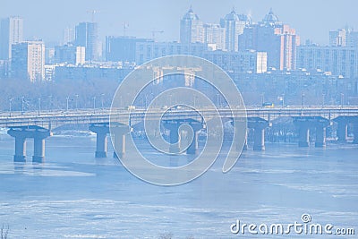 Frozen river. Two parallel bridges. Kiev. Ukraine. Winter snowy river scenery from Kiev. Ukraine. Stock Photo