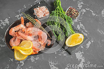 Frozen shrimp are prepared for cooking. Shrimp with spices savory lemon colored pepper dill and sea salt. Food preparation Stock Photo