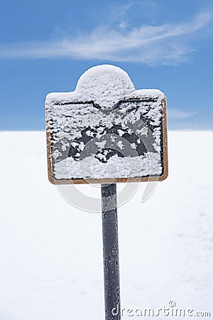 Frozen sign covered in snow Stock Photo