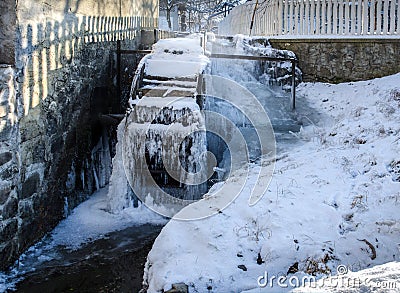 Frozen traditional old water mill in Transylvania region, Romania Stock Photo
