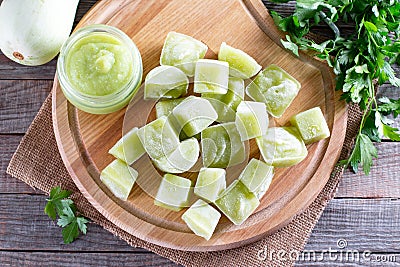 Frozen vegetable puree on table. Frozen zucchini puree cubes. Frozen Food Concept Stock Photo
