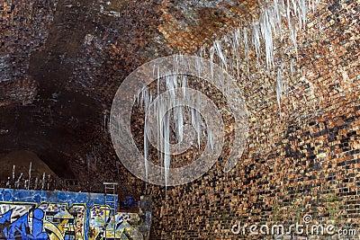 Frozen water icicles in the tunnel Stock Photo