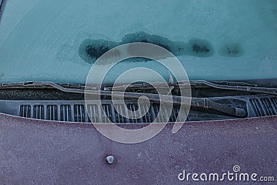 Frozen windscreen and windshield wipers totally covered with ice, caution, poor view causes dangerous driving Stock Photo