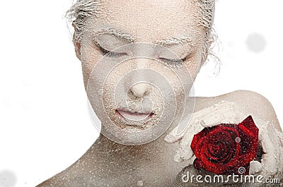 Frozen woman in snow and with rose his hands Stock Photo