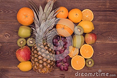 Fruit background with orange, kiwi, grape, apples and lemon on the wooden table Stock Photo