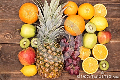 Fruit background with orange, kiwi, grape, apples and lemon on the wooden table Stock Photo