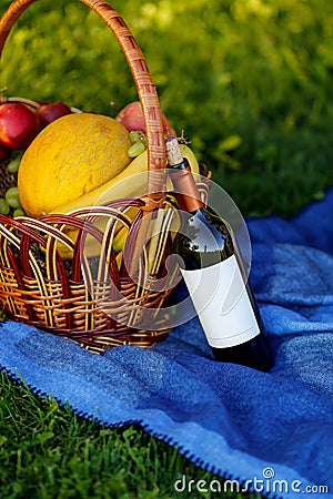 Fruit basket and bottle of wine on the nature Stock Photo