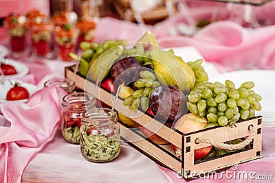 Fruit basket on a wedding table with snacks Stock Photo