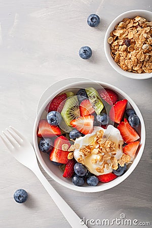 Fruit berry salad with yogurt and granola for healthy breakfast Stock Photo