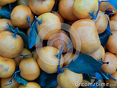 Fruit box with tangerines and green leaves Stock Photo