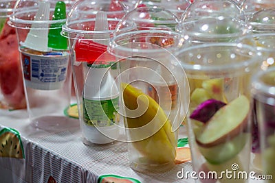 Fruit in cups, sliced for making smoothies on the rack of an outdoor kiosk. Editorial Stock Photo