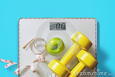 Fruit, dumbbell and scale, fat burn and weight loss concept Stock Photo