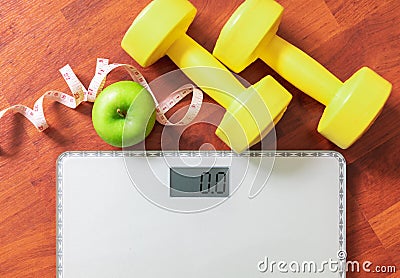 Fruit, dumbbell and scale, fat burn and weight loss concept Stock Photo