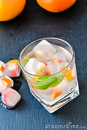 Fruit in ice cubes in water Stock Photo