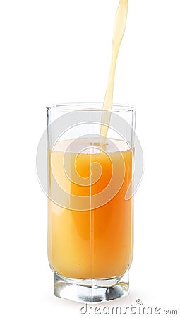 Fruit juice is poured into a glass cup on a white background. Isolated Stock Photo