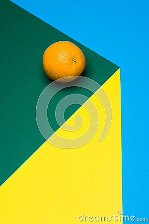 Fruit of orange on a multicolored background, halves of oranges on colored paper. Copy space. Stock Photo