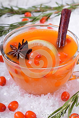 Fruit punch with sea buckthorn berries, citrus and spices in a glass cup Stock Photo