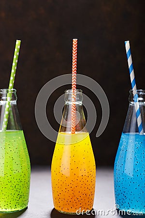 Fruit refreshment beverages in the bottles with paper straws. Stock Photo