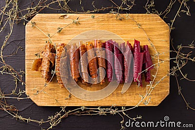 fruit rolls on a wooden board on a black background. Useful sweets. Proper nutrition. Stock Photo