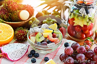 Fruit salad bowl fresh summer fruits and vegetables healthy organic food strawberries orange kiwi blueberries dragon fruit Stock Photo